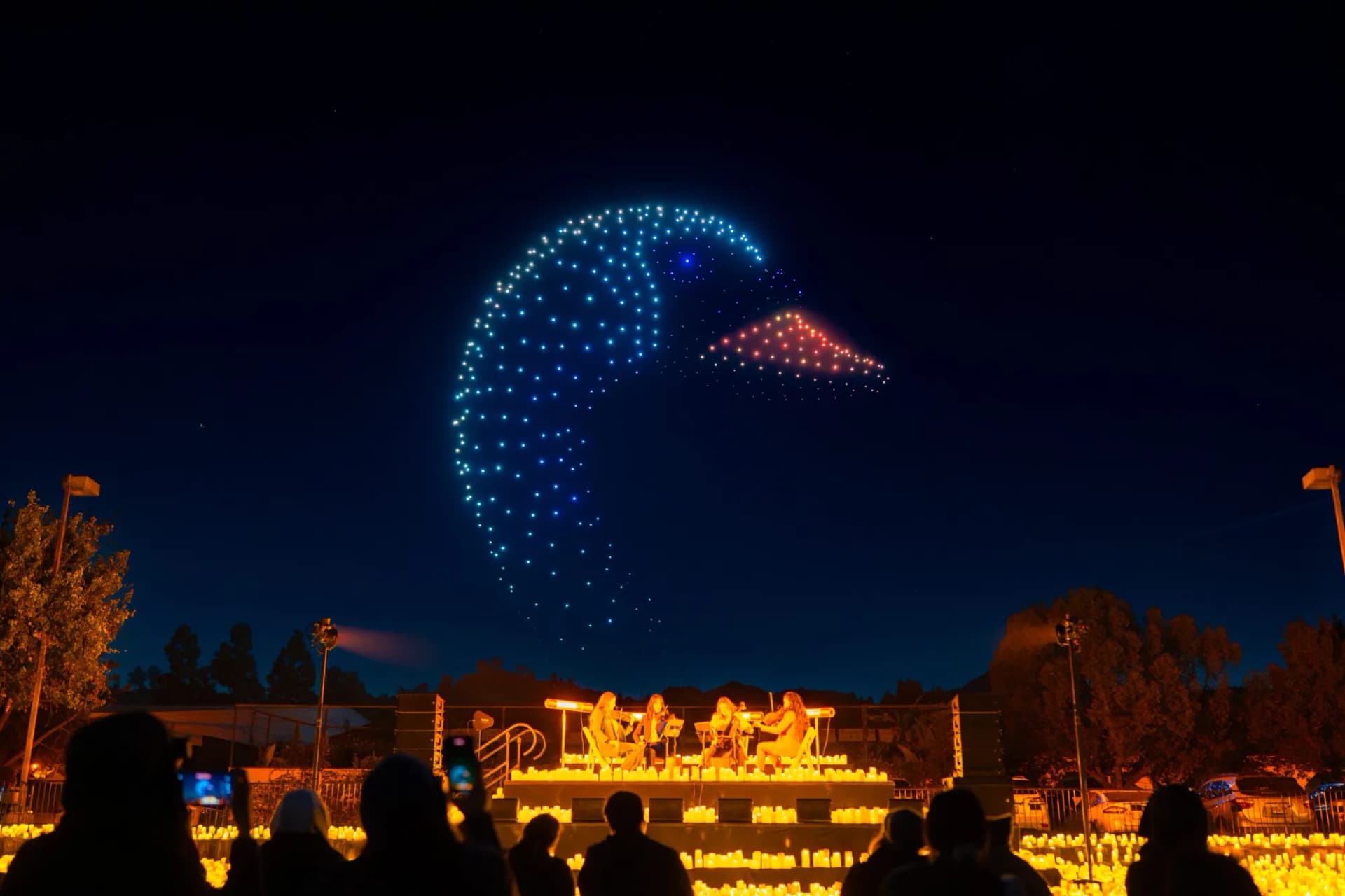 DroneArt drones above a candlelit concert stage and audience