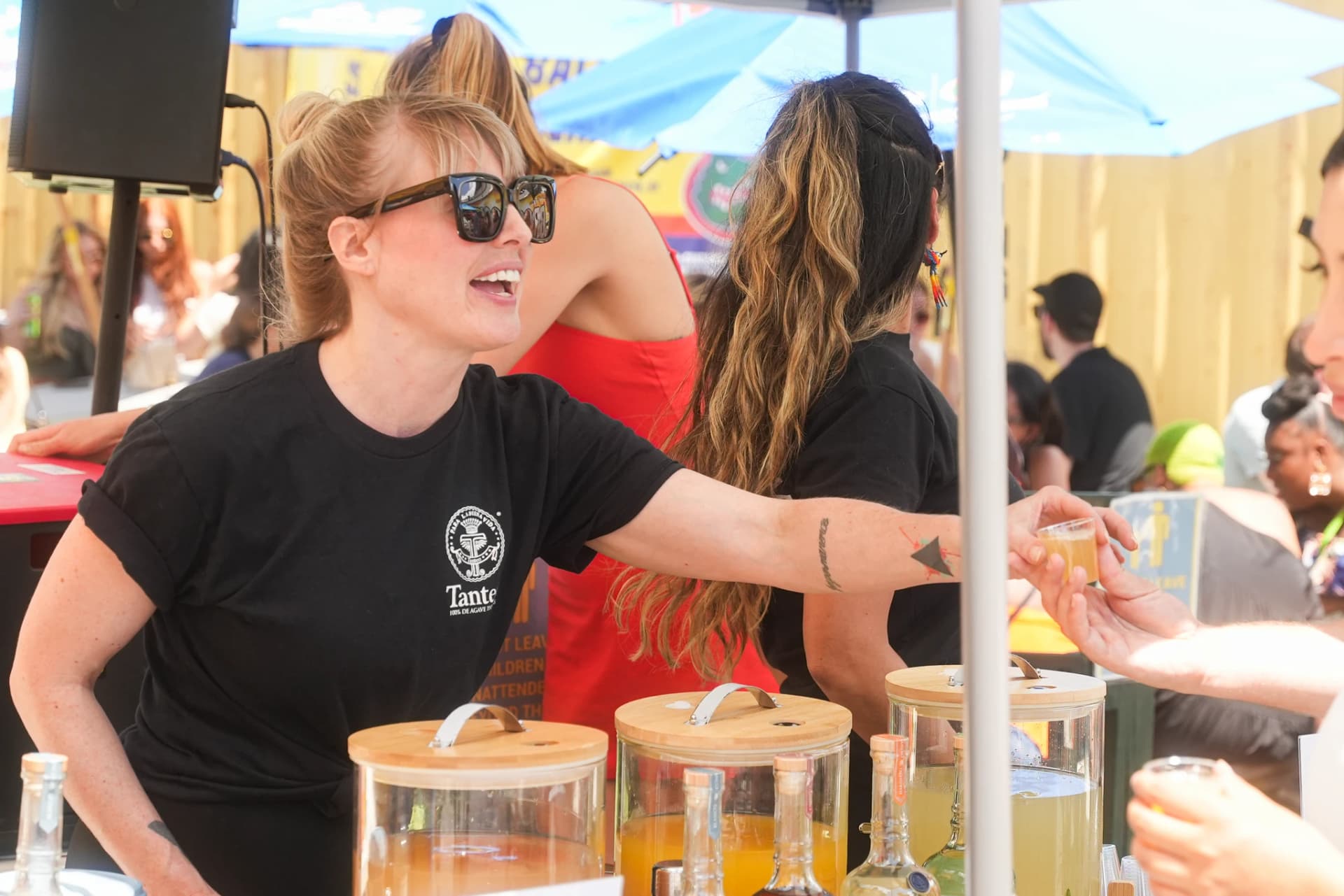 Vendor serving tasting samples to festival attendees